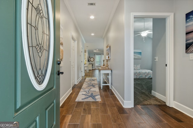 foyer entrance with crown molding and ceiling fan