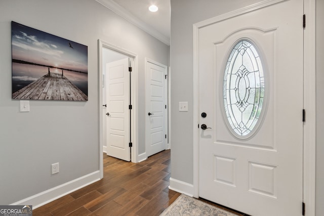 entryway with ornamental molding and dark wood-type flooring