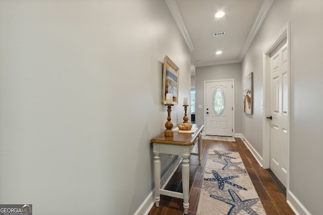 entryway featuring ornamental molding and dark hardwood / wood-style flooring