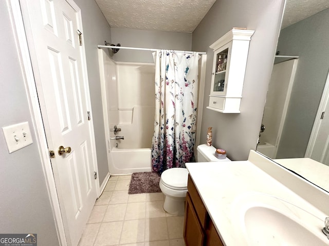 full bathroom with shower / tub combo with curtain, vanity, a textured ceiling, tile patterned floors, and toilet