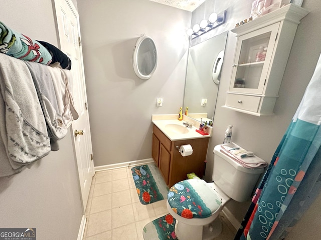 bathroom with vanity, tile patterned floors, and toilet