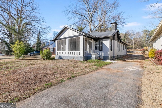 view of front of house featuring a sunroom