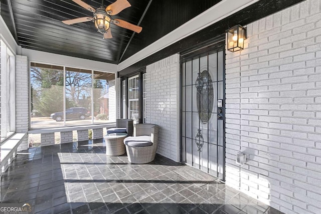 unfurnished sunroom featuring lofted ceiling and ceiling fan