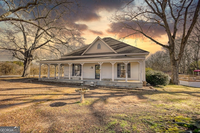 view of front of home with a lawn and covered porch