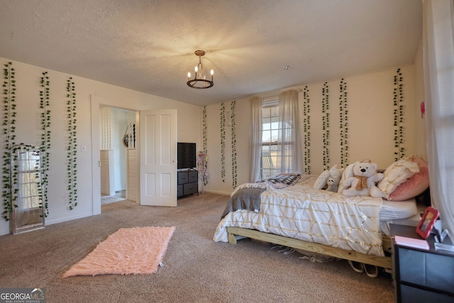 carpeted bedroom featuring a textured ceiling and a notable chandelier