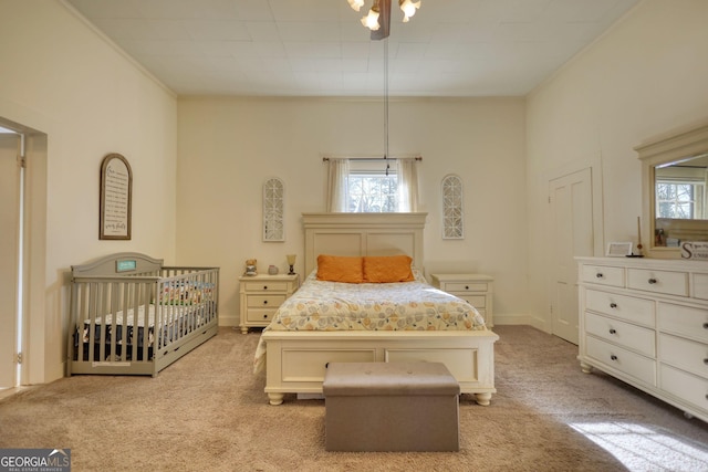 bedroom with light colored carpet and a crib