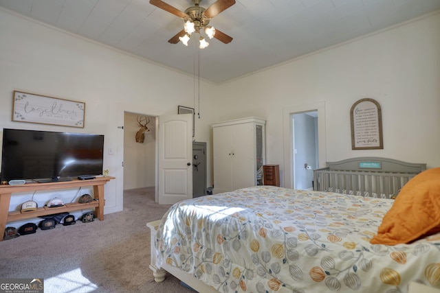 carpeted bedroom with ornamental molding and ceiling fan