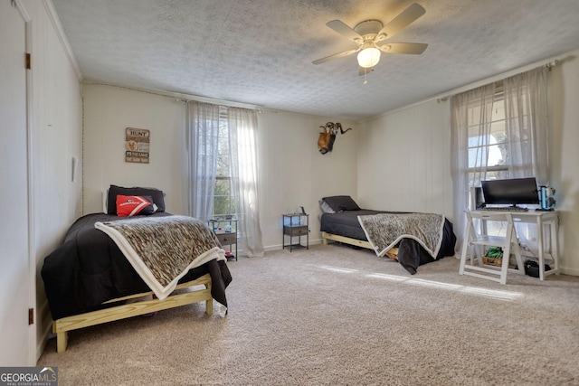 carpeted bedroom with multiple windows, ceiling fan, and a textured ceiling