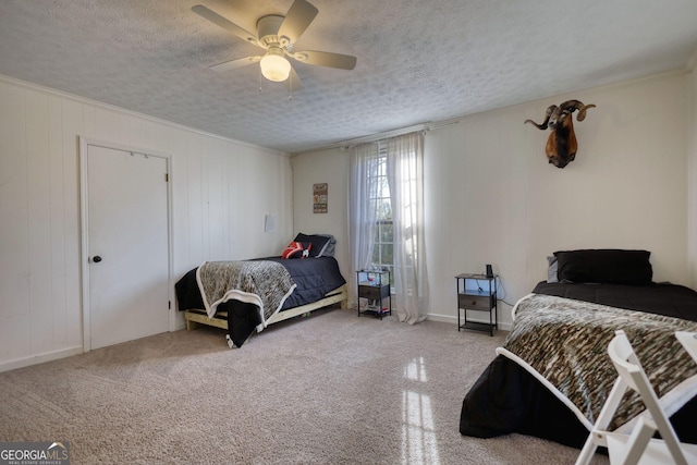 bedroom with ceiling fan and a textured ceiling