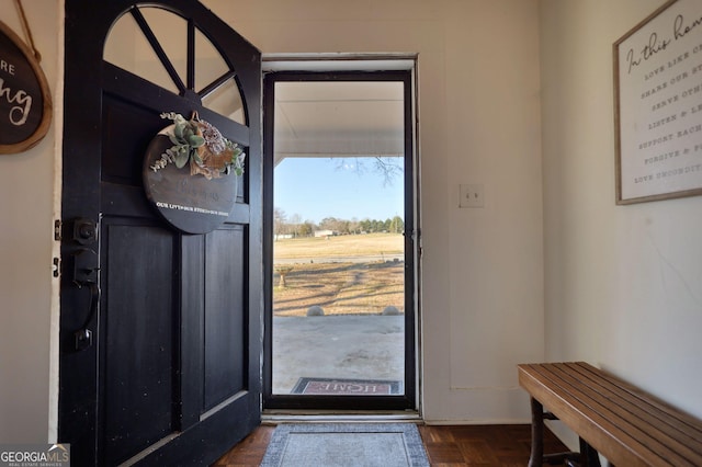 entryway featuring dark parquet floors