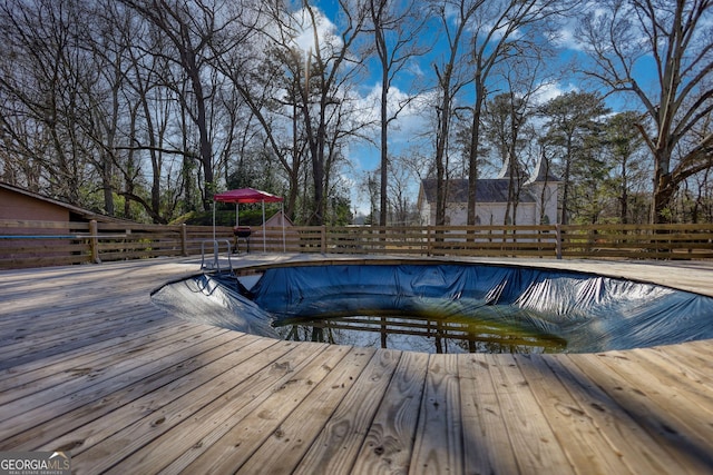 view of swimming pool featuring a wooden deck