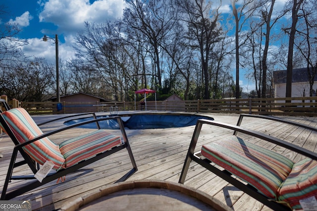 view of swimming pool with a wooden deck