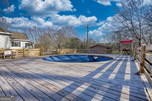 view of swimming pool featuring a wooden deck