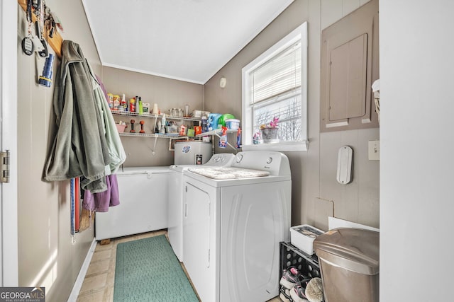 laundry room featuring electric panel and separate washer and dryer