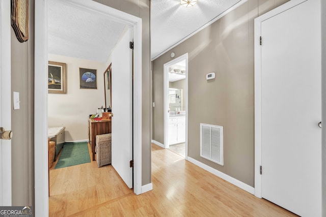 corridor featuring hardwood / wood-style flooring and a textured ceiling