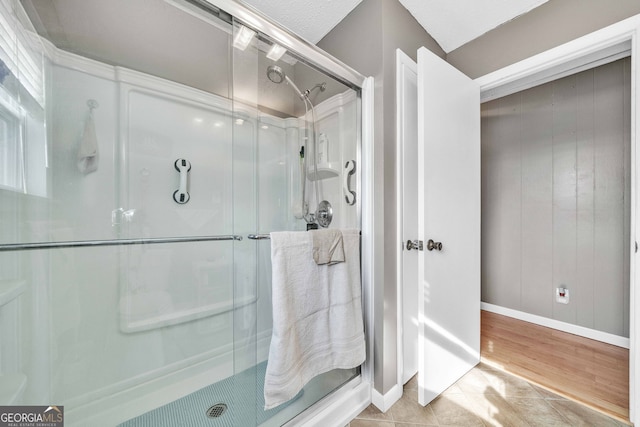 bathroom with tile patterned floors and a shower with shower door