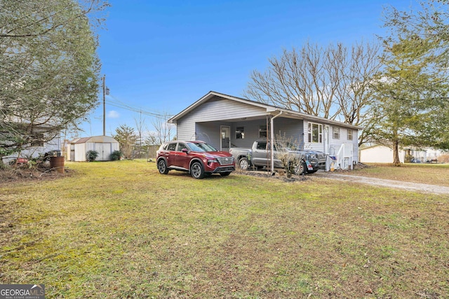 view of front of home with a shed and a front yard