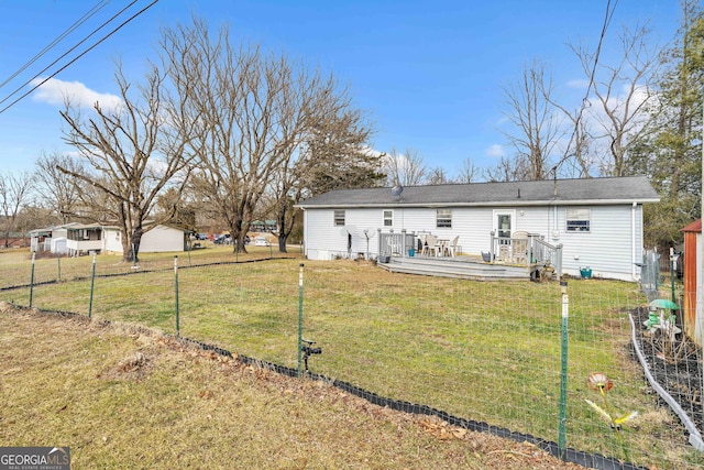 back of house with a yard and a deck