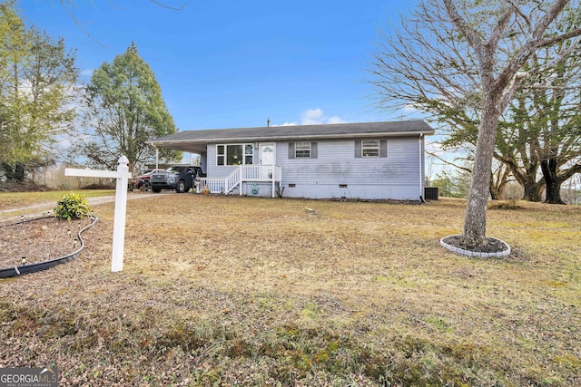 view of front of house with a front yard and a carport