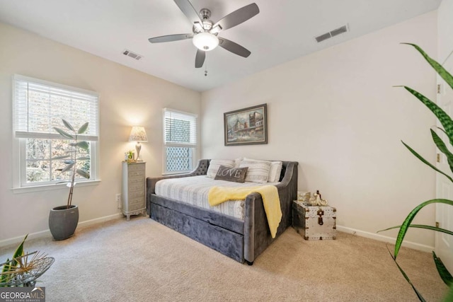 bedroom with light carpet and ceiling fan