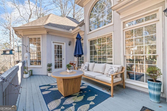 wooden terrace with an outdoor hangout area