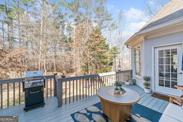 wooden deck with a grill