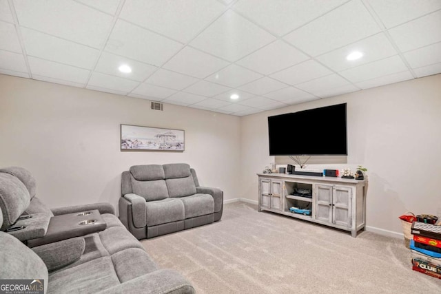 living room with carpet and a drop ceiling