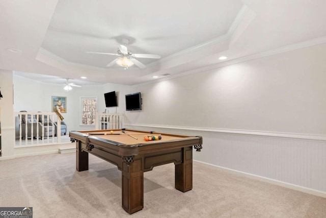 rec room featuring a raised ceiling and light carpet