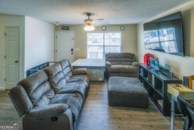 living room with hardwood / wood-style flooring and a textured ceiling