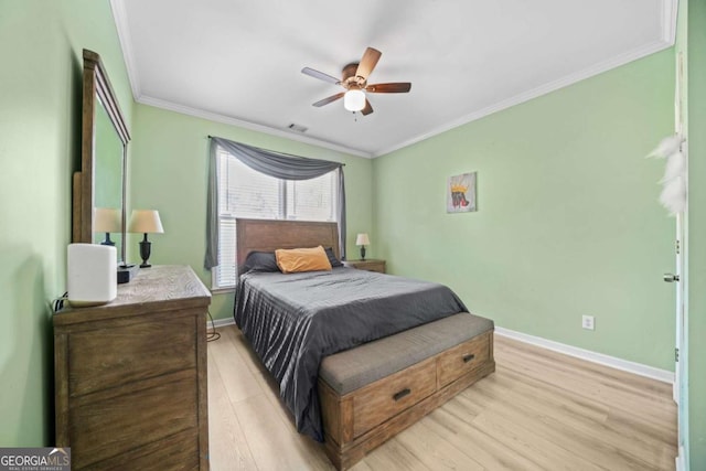 bedroom featuring ceiling fan, ornamental molding, and light hardwood / wood-style floors