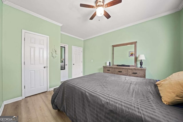 bedroom with ornamental molding, ceiling fan, and light wood-type flooring