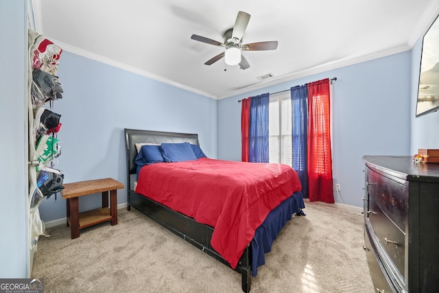 carpeted bedroom featuring crown molding and ceiling fan