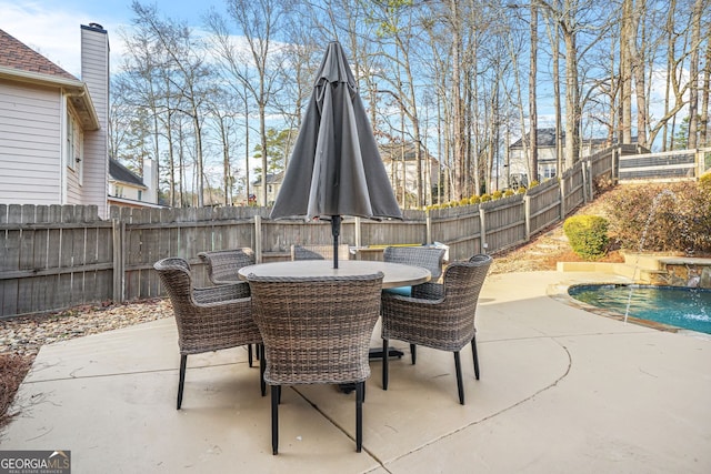 view of patio / terrace featuring pool water feature and a fenced in pool