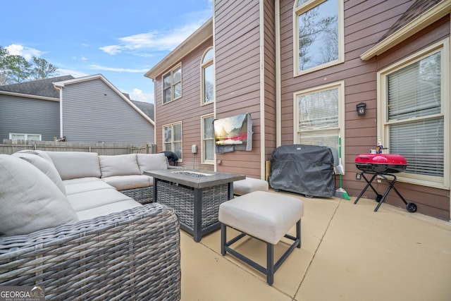 view of patio with a grill and an outdoor living space with a fire pit