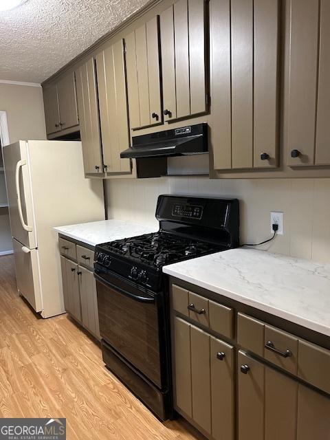 kitchen with crown molding, light hardwood / wood-style flooring, black gas stove, white refrigerator, and a textured ceiling