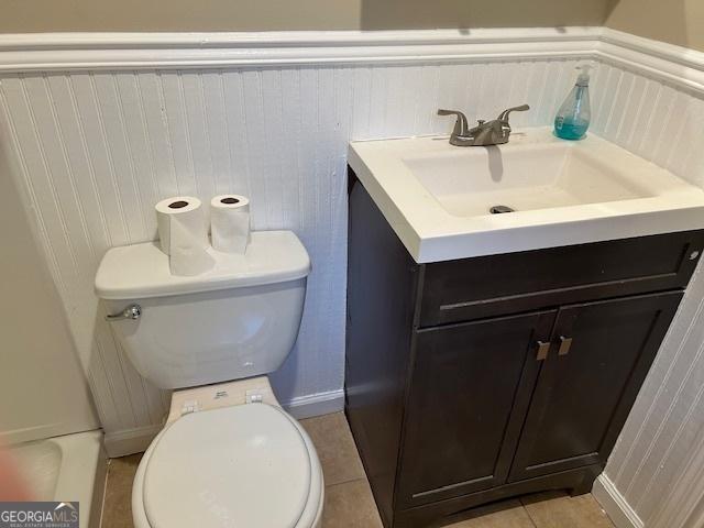 bathroom with vanity, toilet, and tile patterned flooring