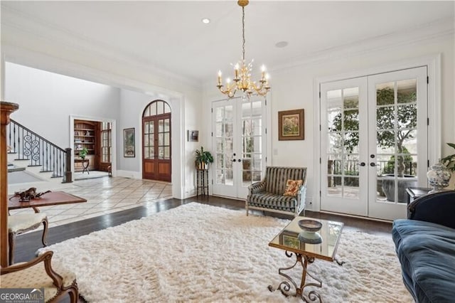 living room featuring hardwood / wood-style flooring, ornamental molding, and french doors