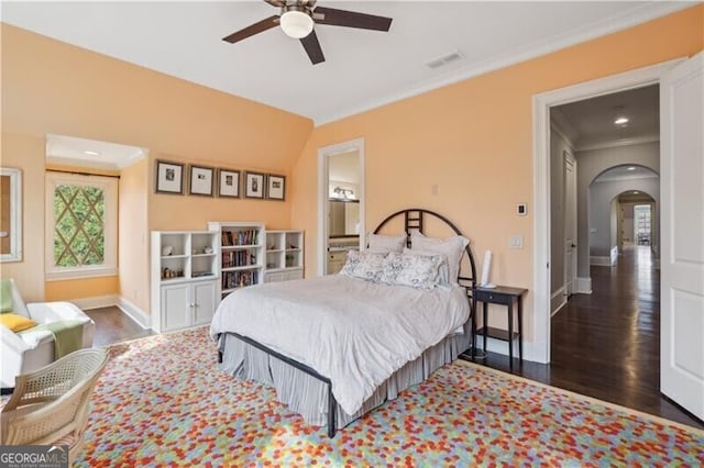 bedroom with dark wood-type flooring, ceiling fan, and ornamental molding