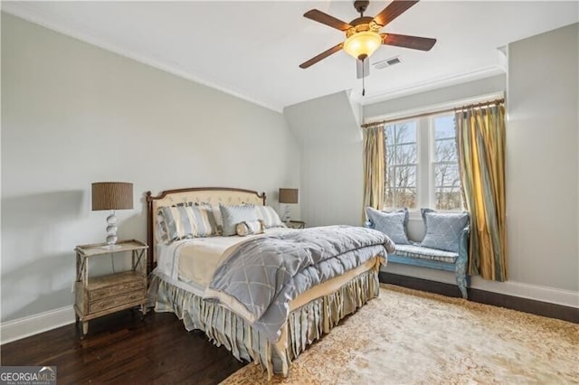 bedroom with dark hardwood / wood-style flooring and ceiling fan