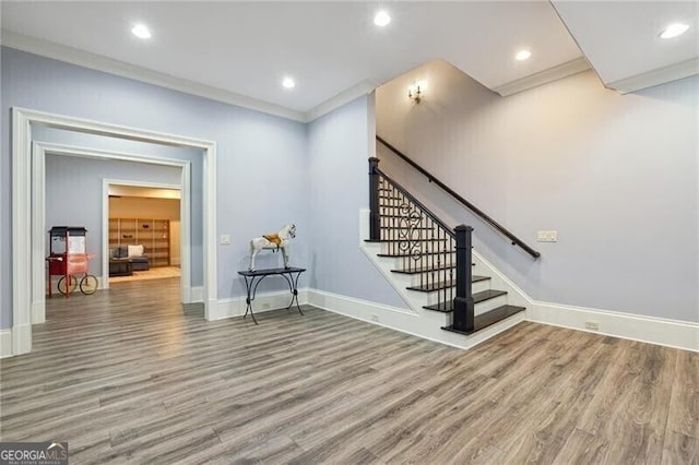 interior space with ornamental molding and hardwood / wood-style floors