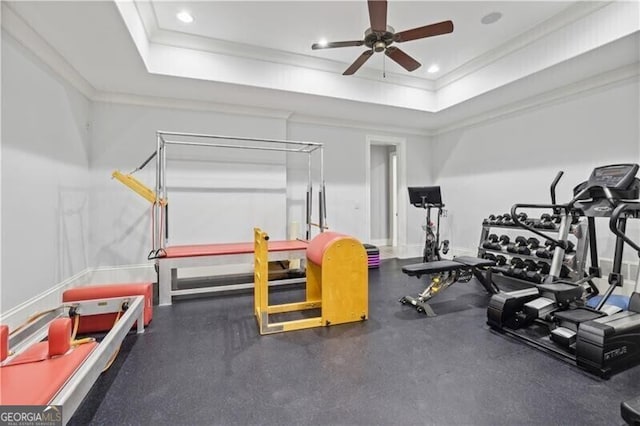 interior space with crown molding, a raised ceiling, and ceiling fan