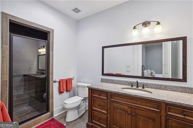 bathroom with vanity, toilet, and walk in shower