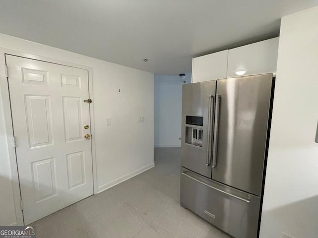 kitchen with white cabinetry and high end fridge