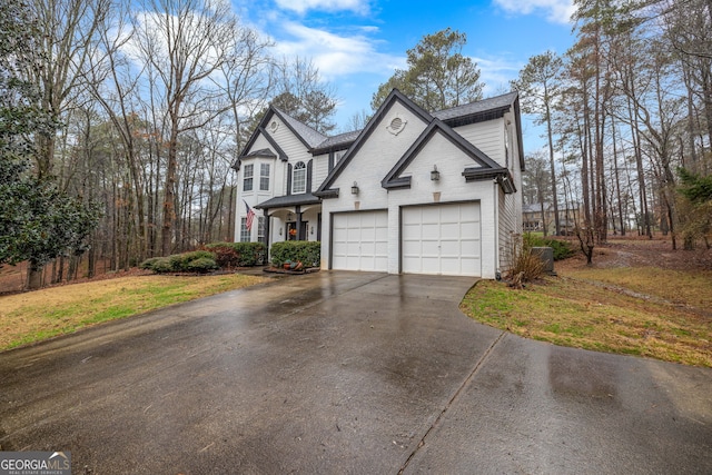 view of front of house featuring a garage and a front lawn