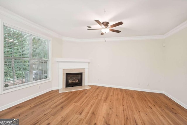 unfurnished living room with ornamental molding, ceiling fan, and light hardwood / wood-style flooring