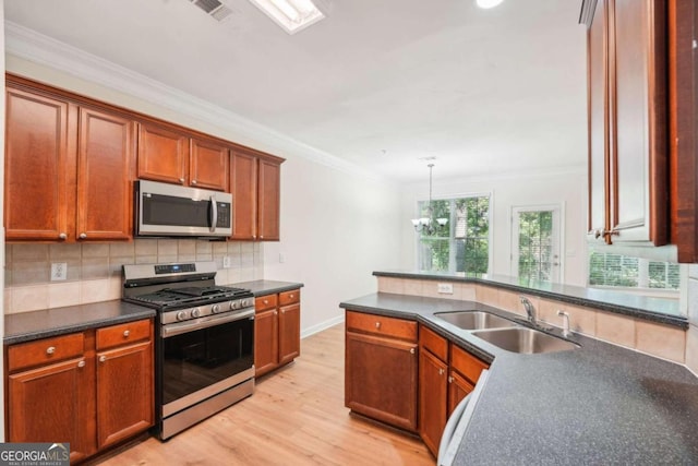 kitchen featuring appliances with stainless steel finishes, sink, decorative backsplash, ornamental molding, and light hardwood / wood-style floors