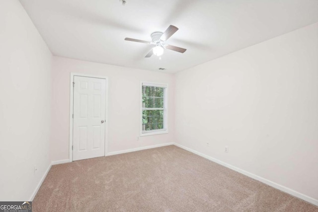 carpeted empty room with ceiling fan