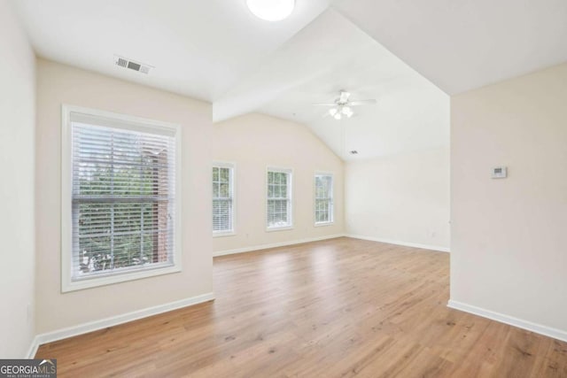 interior space with vaulted ceiling, ceiling fan, and light wood-type flooring