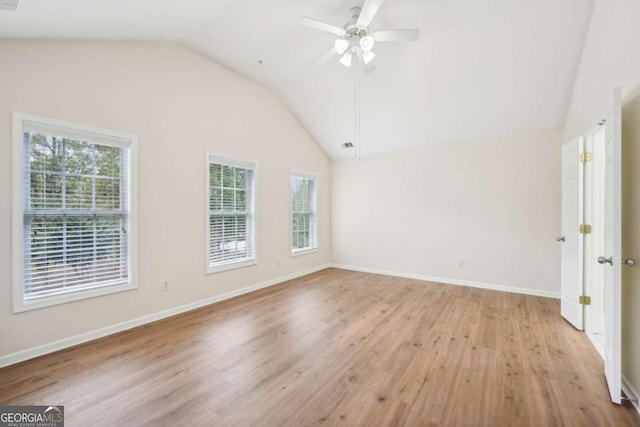 empty room with lofted ceiling, light hardwood / wood-style flooring, and ceiling fan