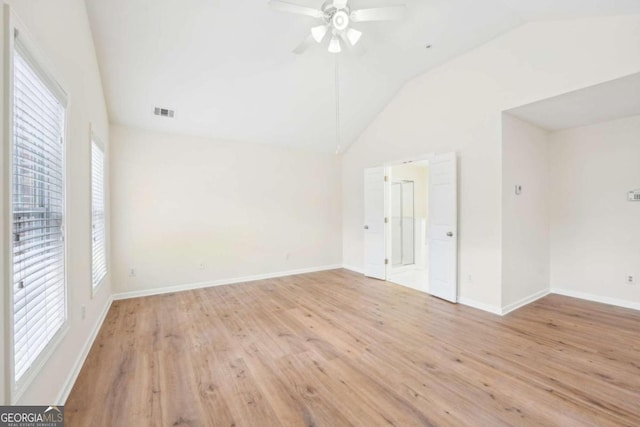 spare room with vaulted ceiling, light hardwood / wood-style floors, and ceiling fan